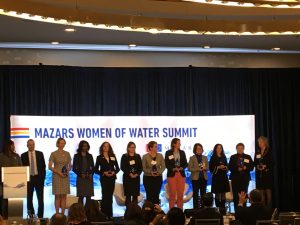 The recipients of the Top 10 Most Influential Women in Water awards stand with the masters of ceremonies at the Women of Water Summit. Pictured are (left to right): Tifphani White-King, Jon Freedman, Eleanor Allen, Nadine Leslie, Karen Sands, Christine Boyle, Karen Pallansch, Sarah Stevenson, Diane VanDe Hei, Adrienne Esposito, Bernadette Sohler, and Debra Coy. Mariah Walters Orose/WEF